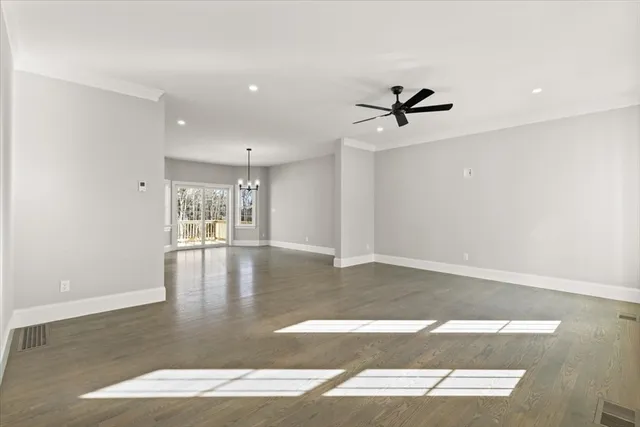 a view of a livingroom with a ceiling fan window and wooden floor