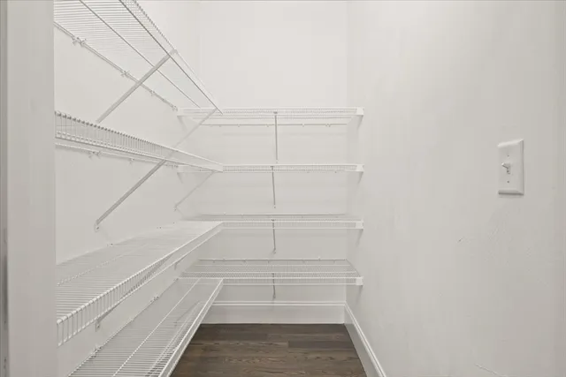 a view of walk in closet with empty racks
