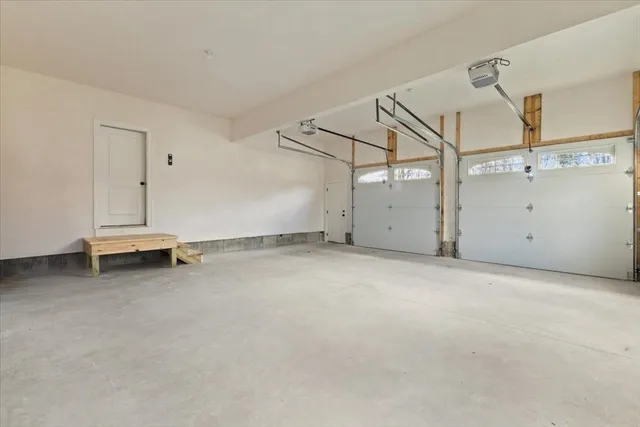 an empty room with staircase and white walls