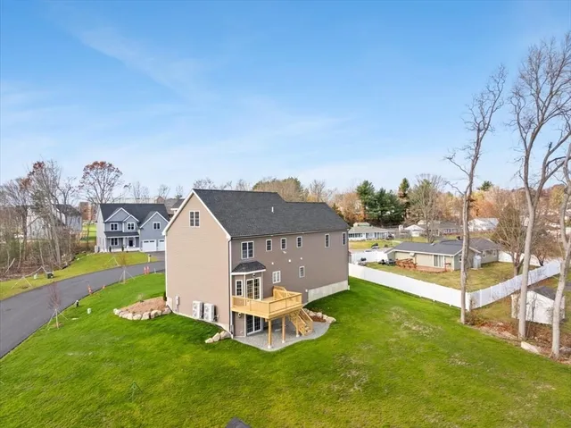 a view of a house with a yard and sitting area