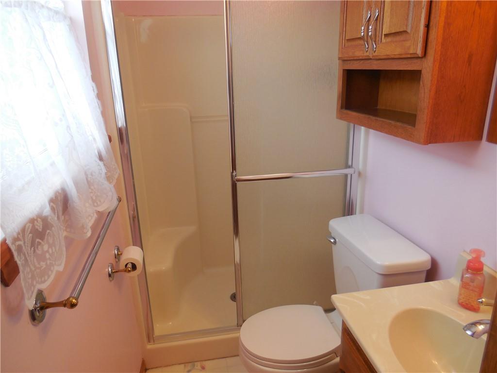 4575 Tuscarawas Road Beaver, PA 15009 - Photo 16 of 24 a white toilet sitting next to a bathroom sink and a mirror