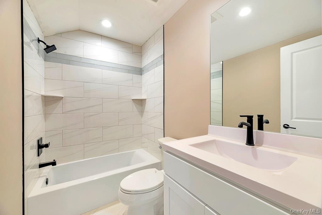 514 Neighborhood Road Shirley, NY 11967 - Photo 9 of 20 a bathroom with a bathtub shower sink vanity and toilet