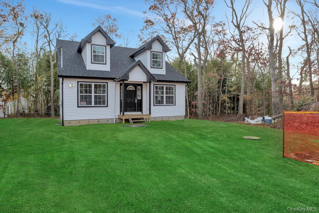 514 Neighborhood Road Shirley, NY 11967 - Photo 2 of 20 a front view of a house with a garden