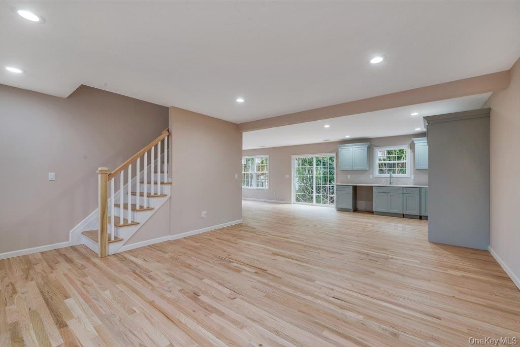 514 Neighborhood Road Shirley, NY 11967 - Photo 3 of 20 a view of an empty room with wooden floor and a window