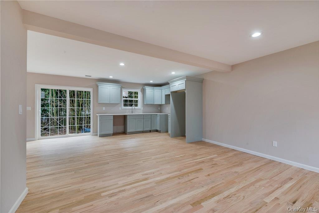 514 Neighborhood Road Shirley, NY 11967 - Photo 18 of 20 a view of an empty room with wooden floor and a window