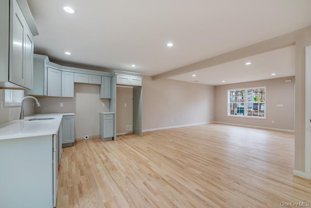 514 Neighborhood Road Shirley, NY 11967 - Photo 19 of 20 a view of an empty room with a window and wooden floor