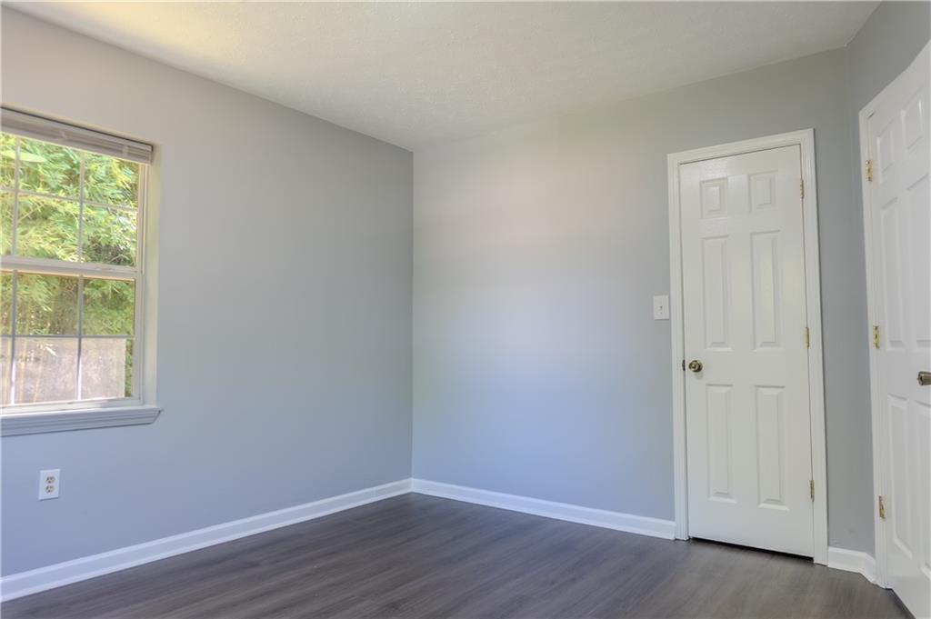 53 Washington Drive Forsyth, GA 31029 - Photo 13 of 19 an empty room with wooden floor and windows