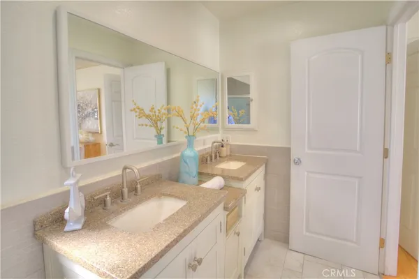 a bathroom with a granite countertop sink a mirror and a