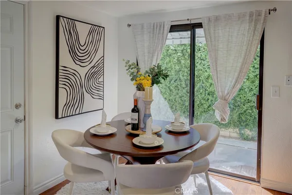 a view of a dining room with furniture window and wooden floor