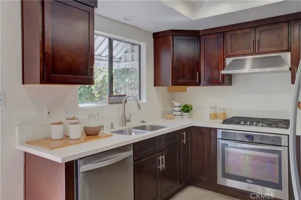 a kitchen with a sink stove top oven and cabinets
