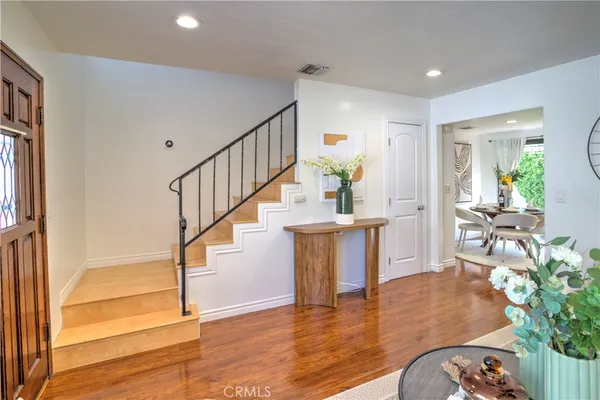 a view of entryway and hall with wooden floor