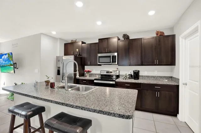 a kitchen with granite countertop a sink and cabinets