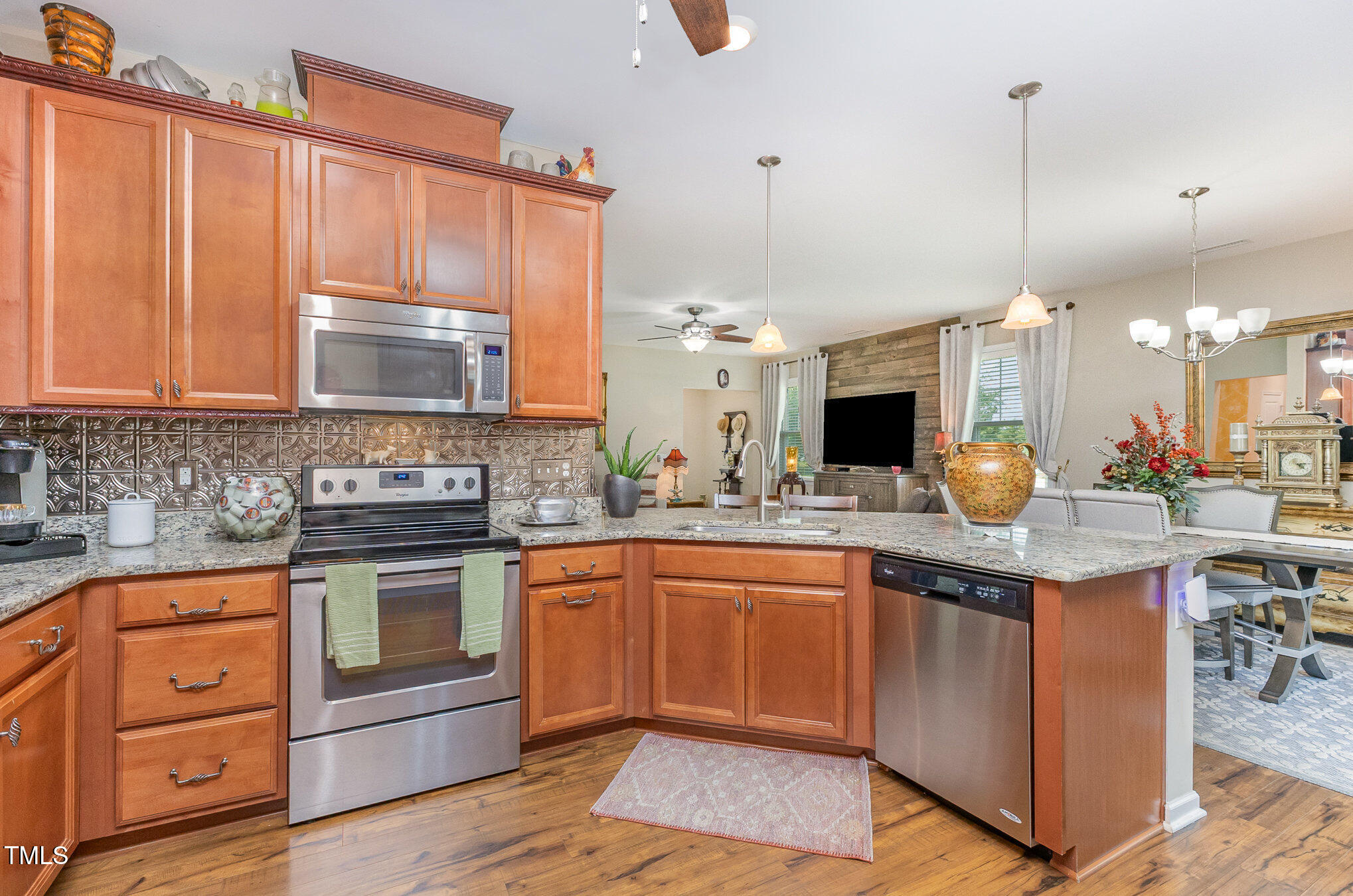 1205 Barnford Mill Road Wake Forest, NC 27587 - Photo 7 of 17 a kitchen with stainless steel appliances granite countertop a stove a sink and a microwave