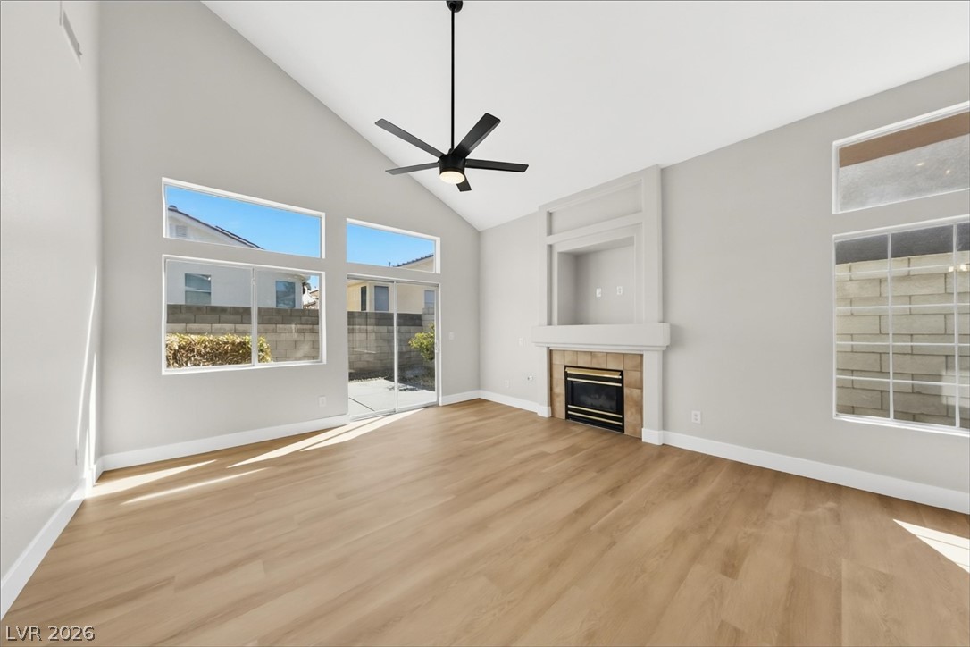 1906 Cardinal Point Street Henderson, NV 89012 - Photo 10 of 20 High vaulted ceilings and rich wood-style flooring elevate this comfortable hearthside gathering space.