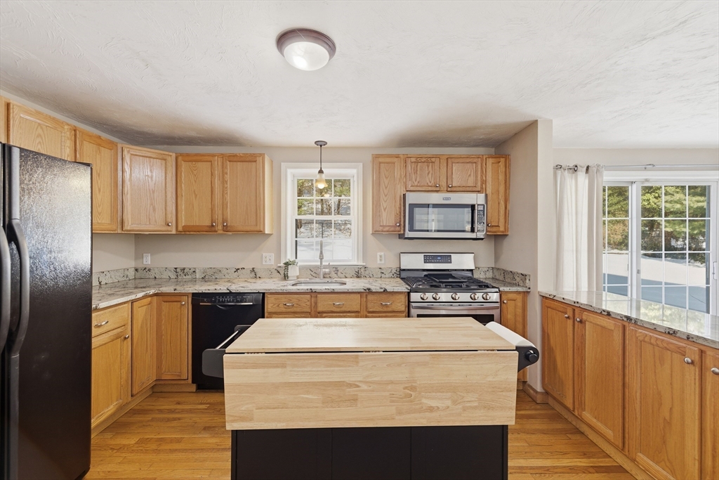318 Old Mill Road Barnstable, MA 02648 - Photo 13 of 36 a kitchen with stainless steel appliances granite countertop a stove top oven a sink and a refrigerator