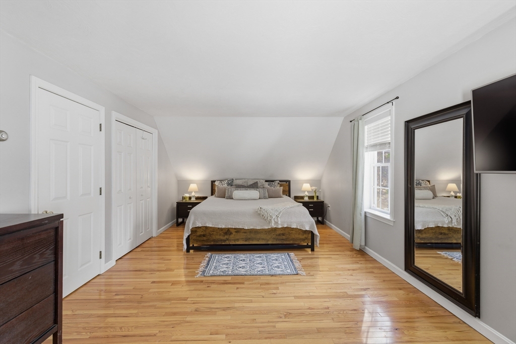 318 Old Mill Road Barnstable, MA 02648 - Photo 22 of 36 a spacious bedroom with a bed and wooden floor