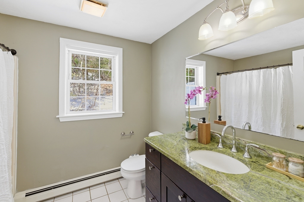 318 Old Mill Road Barnstable, MA 02648 - Photo 24 of 36 a bathroom with a granite countertop sink mirror vanity and toilet