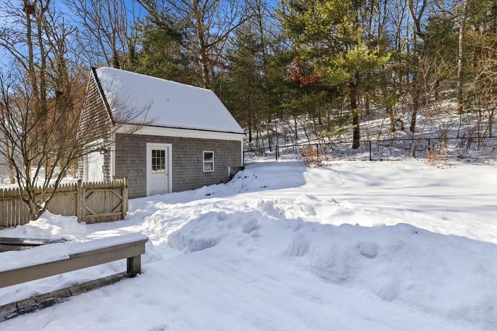 318 Old Mill Road Barnstable, MA 02648 - Photo 30 of 36 a backyard of a house with large trees and outdoor seating
