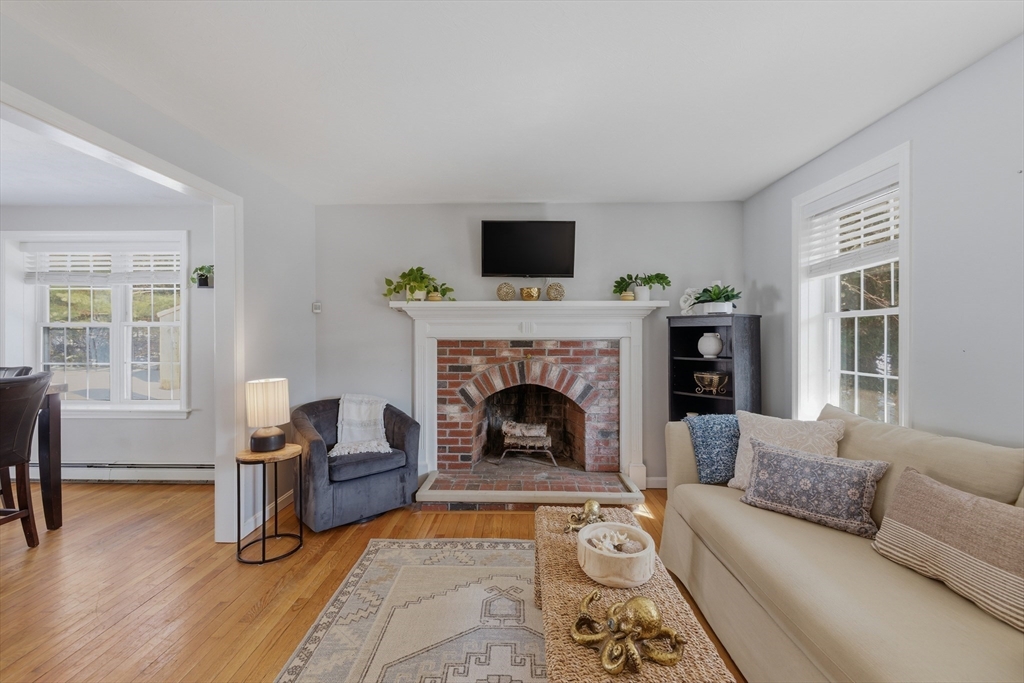 318 Old Mill Road Barnstable, MA 02648 - Photo 5 of 36 a living room with furniture and a fireplace