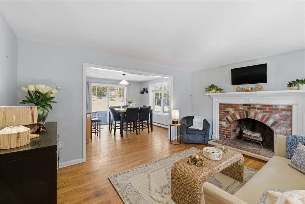 318 Old Mill Road Barnstable, MA 02648 - Photo 6 of 36 a living room with furniture a fireplace and a flat screen tv