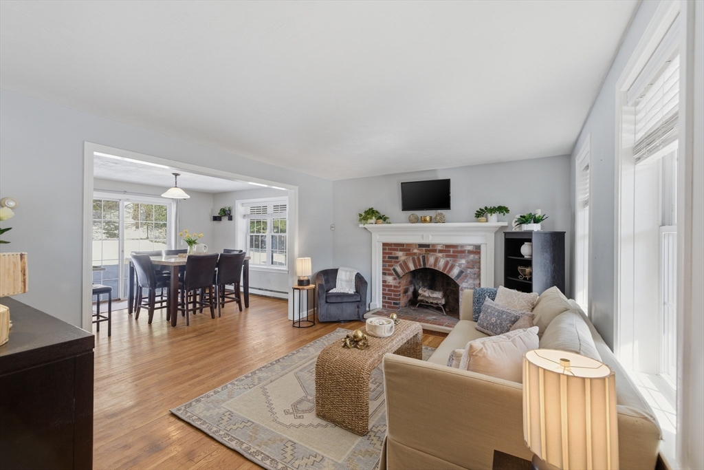 318 Old Mill Road Barnstable, MA 02648 - Photo 8 of 36 a living room with furniture a fireplace and a flat screen tv