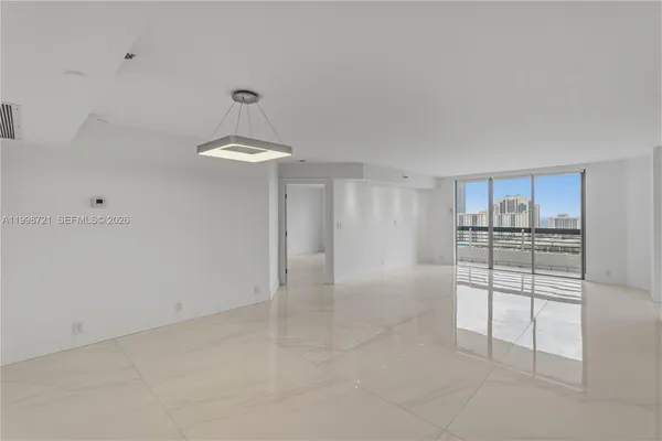 a bedroom with a large bed and a large window