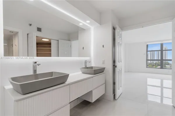 a spacious bedroom with a bed and a window