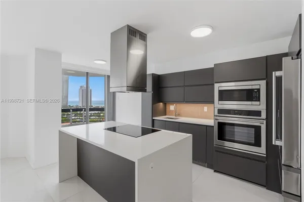 a kitchen with stainless steel appliances a stove and a refrigerator