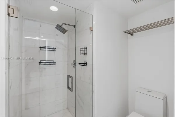 a bathroom with a shower a toilet and sink