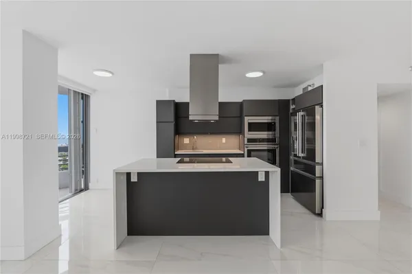 a kitchen with stainless steel appliances granite countertop a sink and a stove