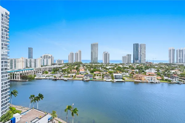 a view of a balcony with a floor to ceiling window and palm tree