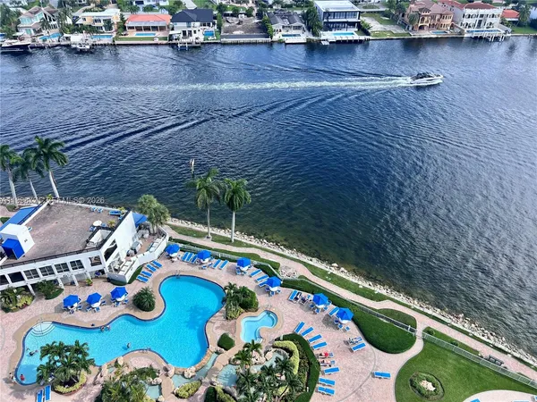 a view of a lake with boats and trees in the background