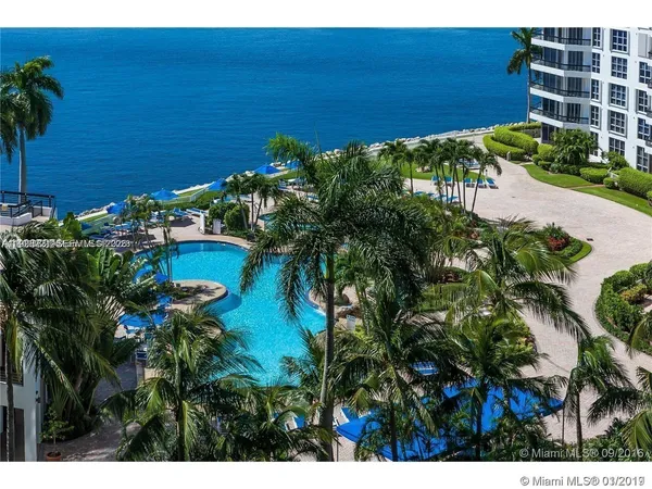 a view of a lake with boats and trees in the background