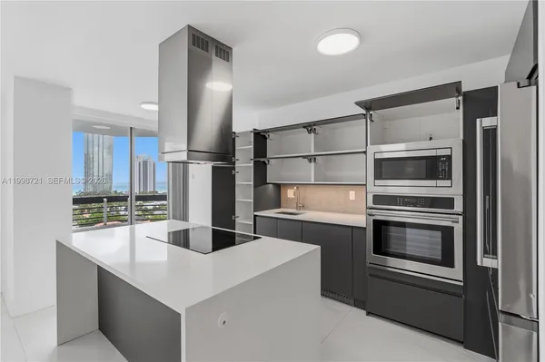 a large kitchen with cabinets and stainless steel appliances
