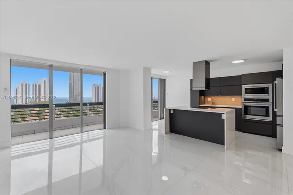 a large kitchen with cabinets and stainless steel appliances