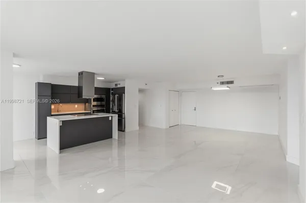 a open kitchen with cabinets and stainless steel appliances