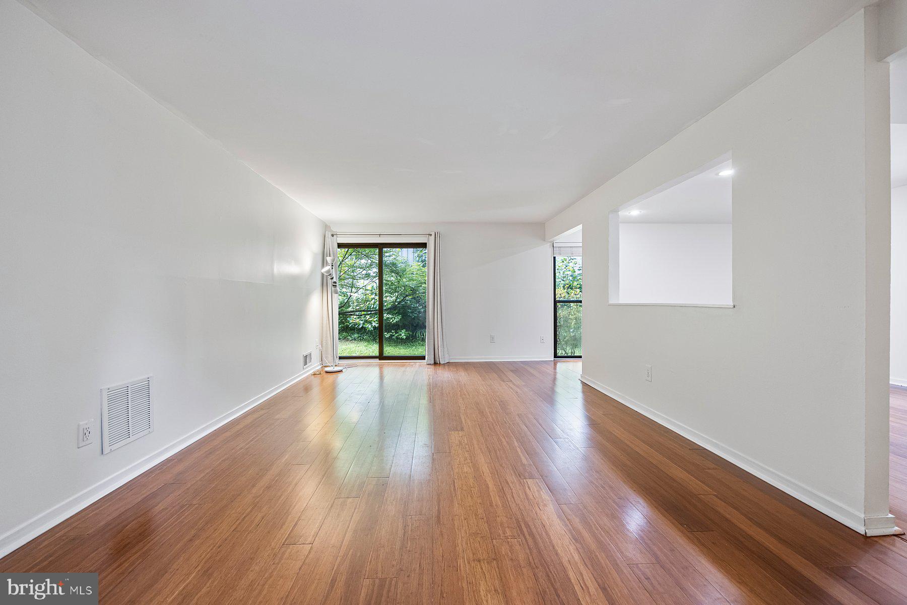 8964 Blue Pool Columbia, MD 21045 - Photo 12 of 36 a view of an empty room with wooden floor and a window