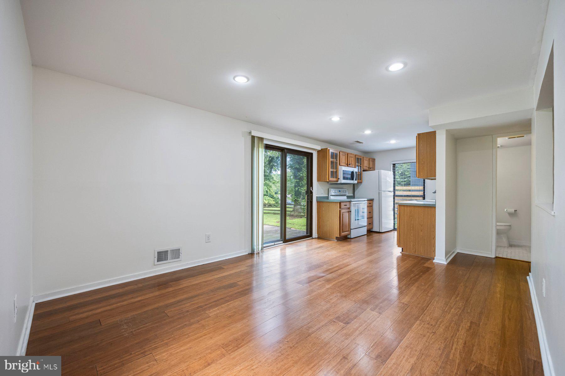 8964 Blue Pool Columbia, MD 21045 - Photo 17 of 36 a view of a big room with wooden floor and windows