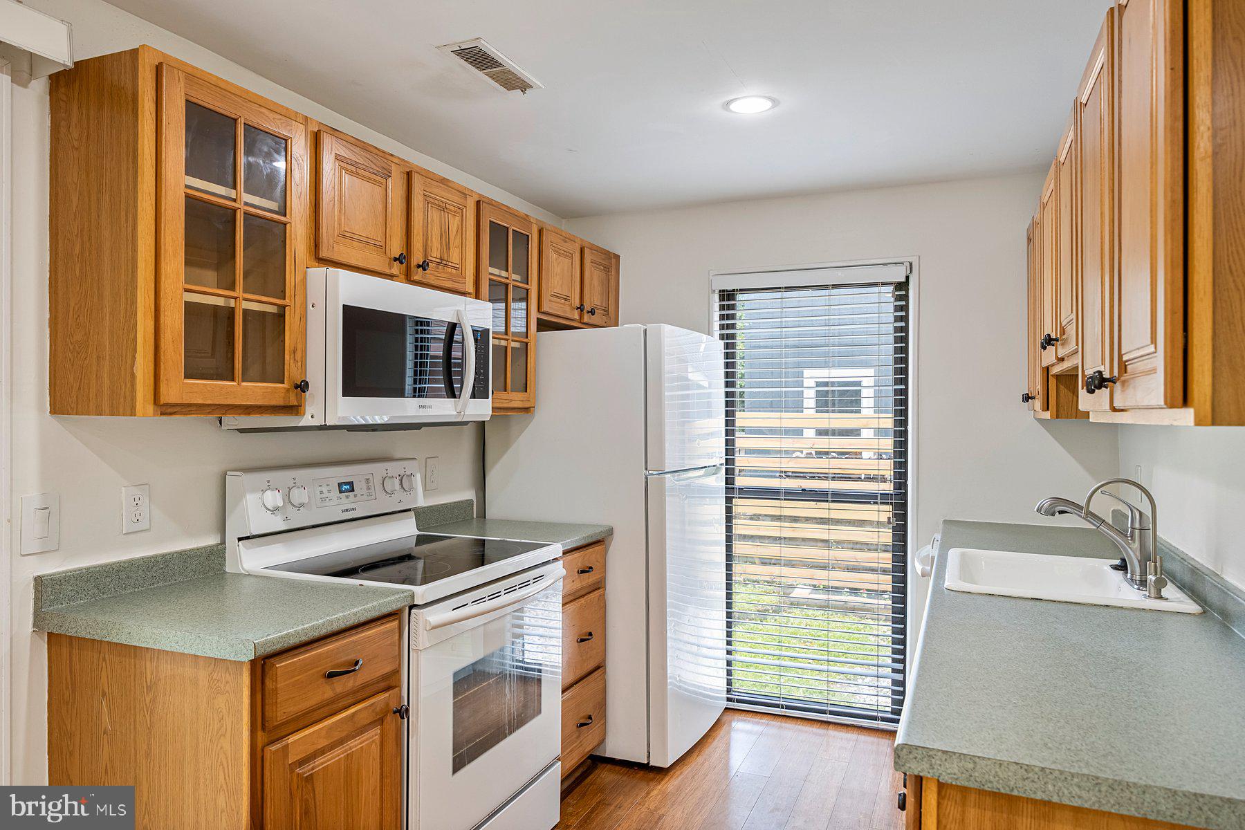 8964 Blue Pool Columbia, MD 21045 - Photo 21 of 36 a kitchen with stainless steel appliances granite countertop a sink a stove and a refrigerator