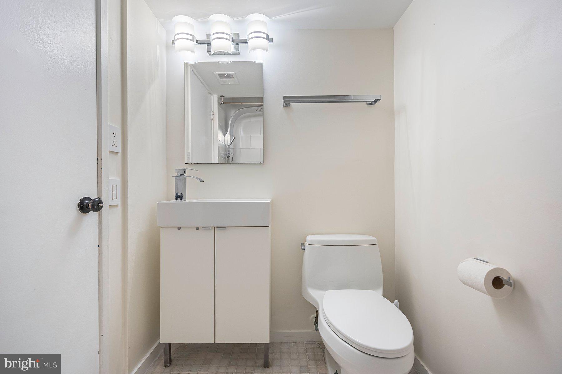8964 Blue Pool Columbia, MD 21045 - Photo 23 of 36 a white toilet sitting next to a bathroom sink