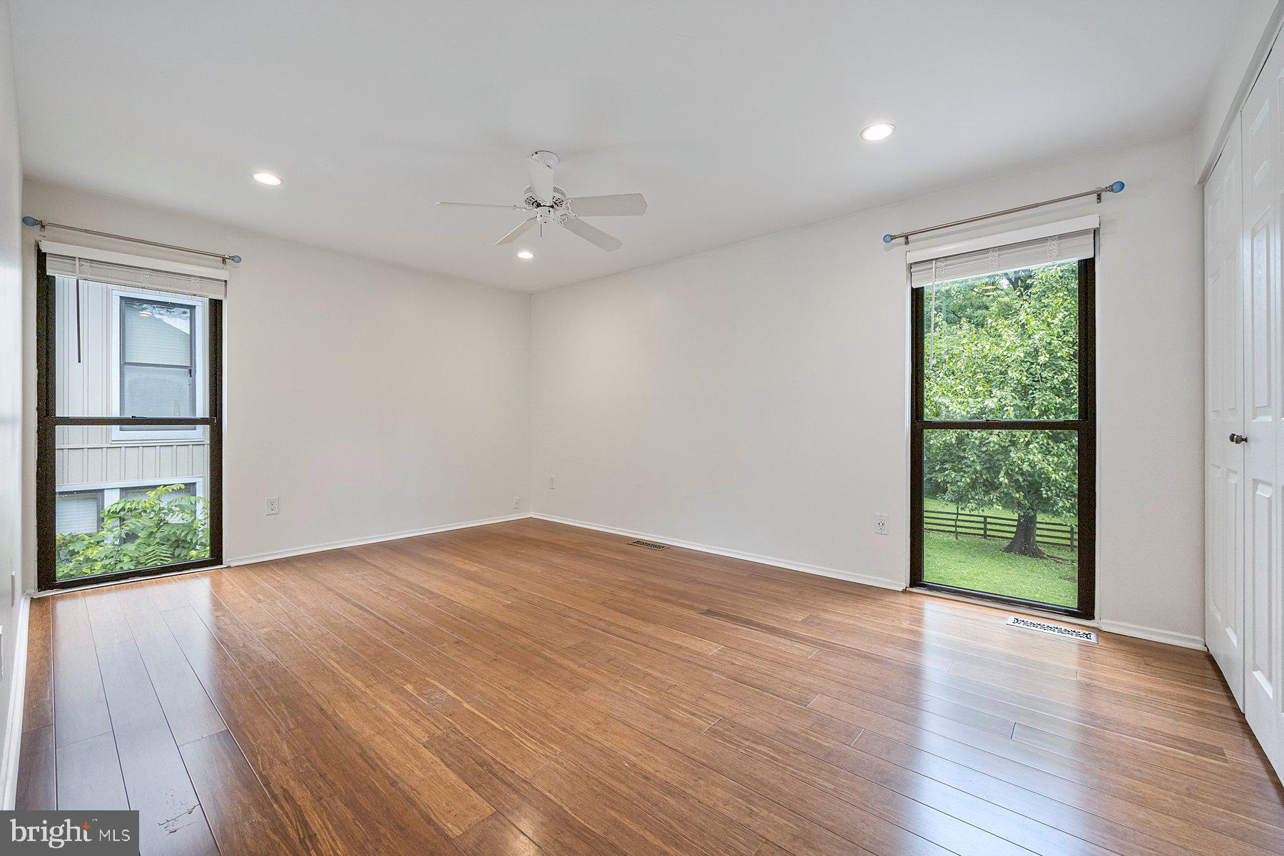 8964 Blue Pool Columbia, MD 21045 - Photo 28 of 36 an empty room with wooden floor and windows