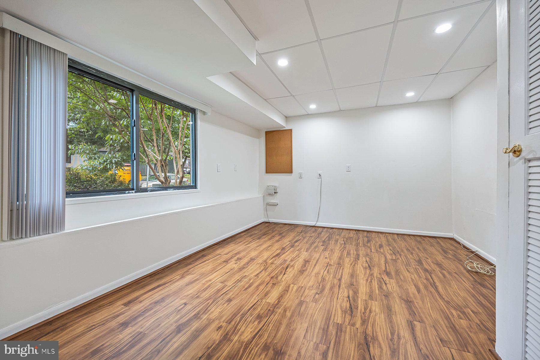 8964 Blue Pool Columbia, MD 21045 - Photo 34 of 36 an empty room with wooden floor and windows