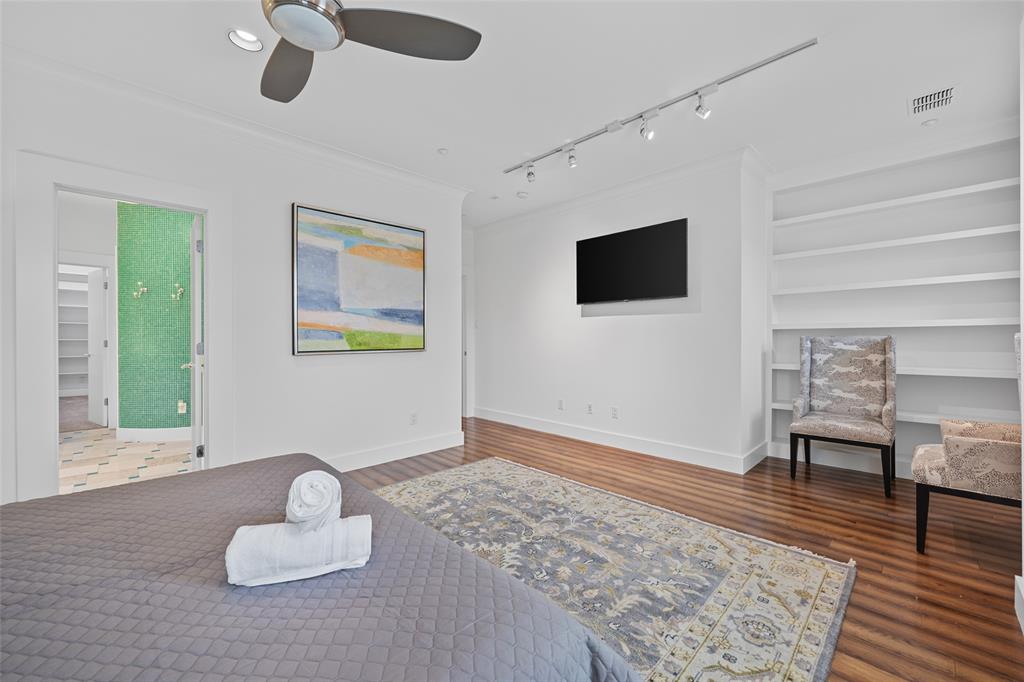 4312 McKinney Avenue, Unit 4 Dallas, TX 75205 - Photo 12 of 34 Bedroom featuring wood finished floors, crown molding, track lighting, and ceiling fan