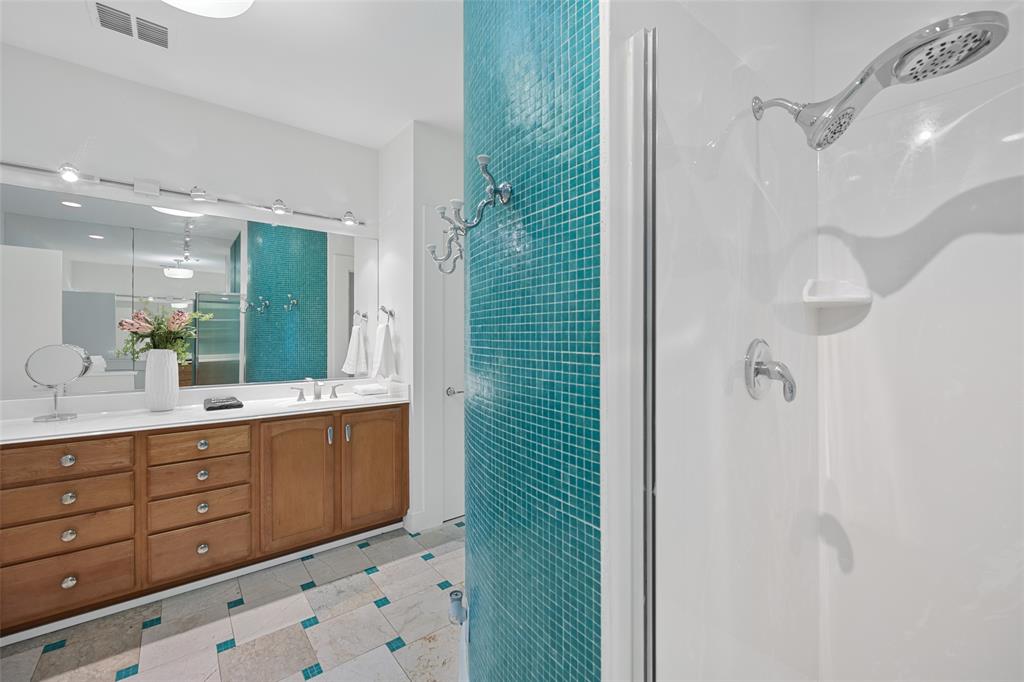 4312 McKinney Avenue, Unit 4 Dallas, TX 75205 - Photo 16 of 34 Bathroom featuring a stall shower, double vanity, and tile walls