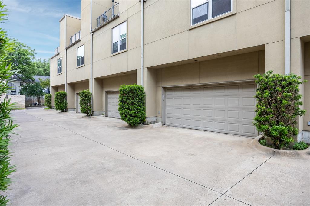 4312 McKinney Avenue, Unit 4 Dallas, TX 75205 - Photo 30 of 34 View of property featuring an attached garage and concrete driveway