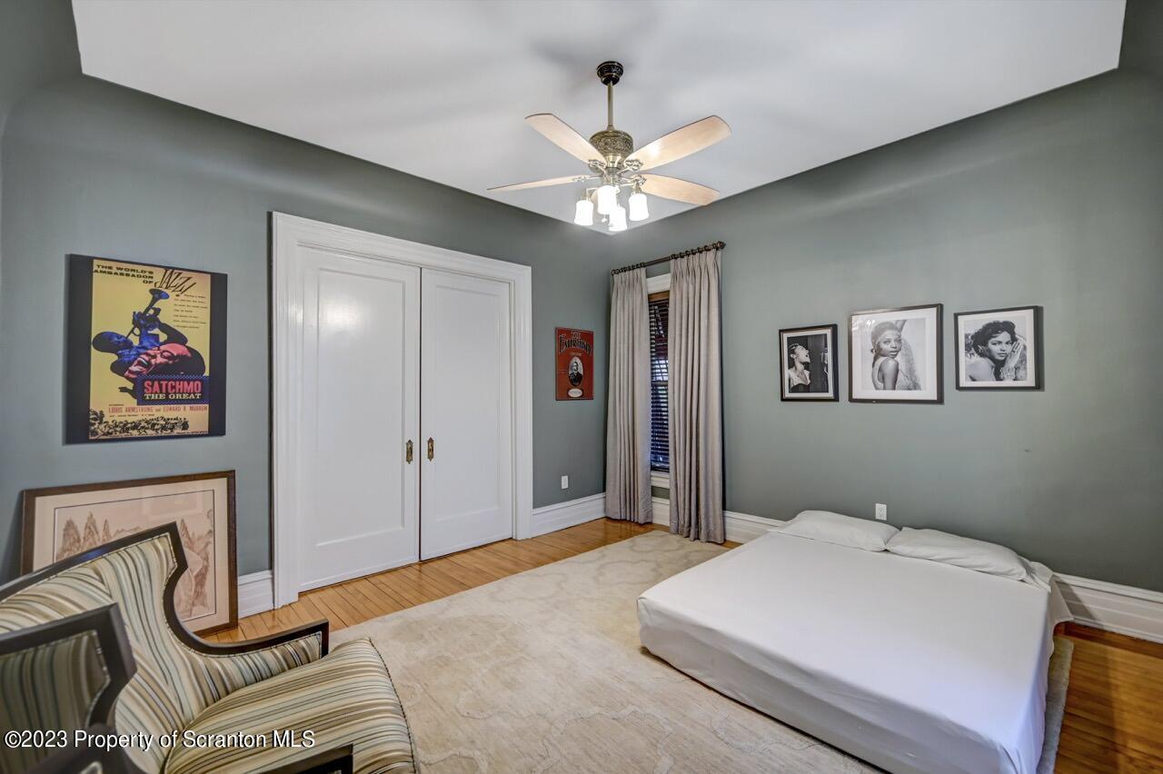 1000 Clay Avenue Scranton, PA 18510 - Photo 36 of 90 a bedroom with a bed and a chandelier