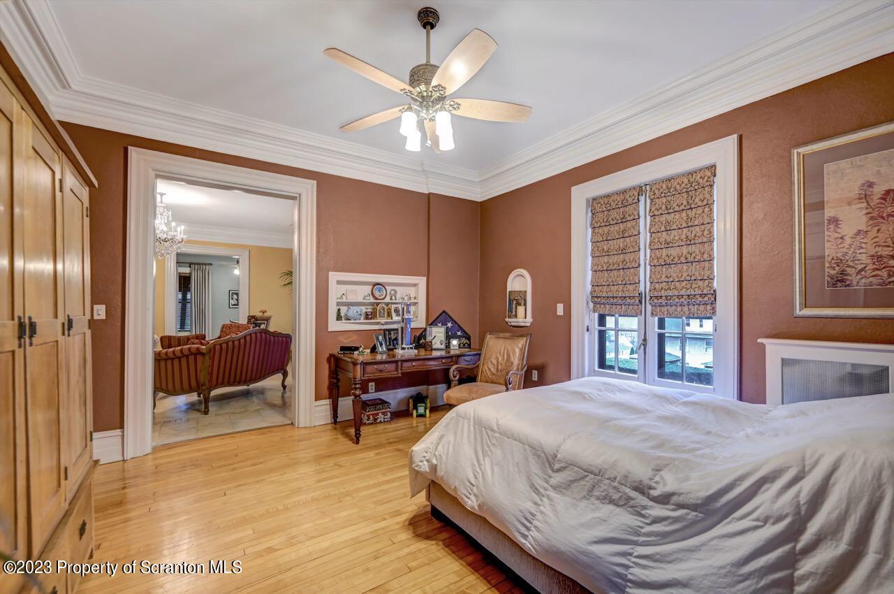 1000 Clay Avenue Scranton, PA 18510 - Photo 38 of 90 a bedroom with a large bed and a chandelier