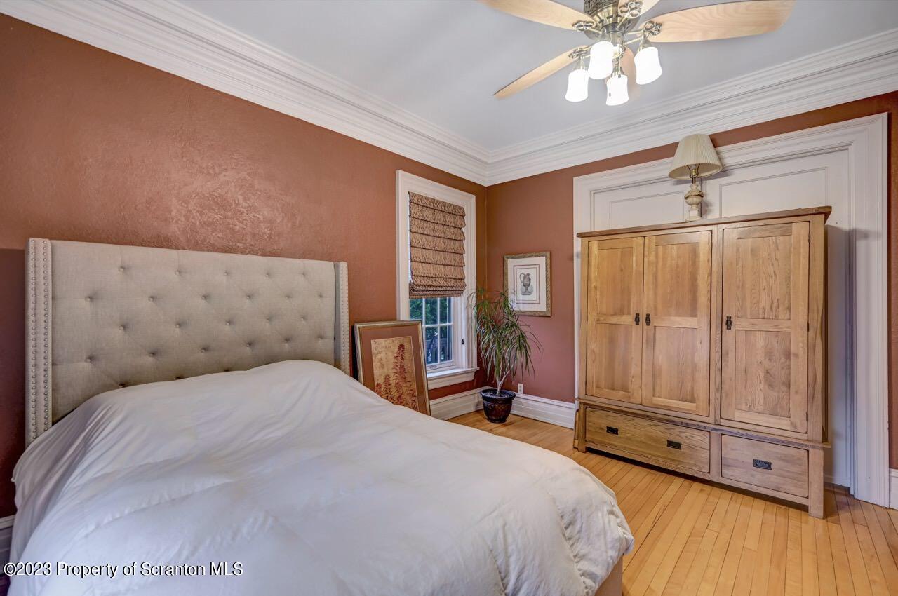 1000 Clay Avenue Scranton, PA 18510 - Photo 39 of 90 a bedroom with a large bed and a chandelier