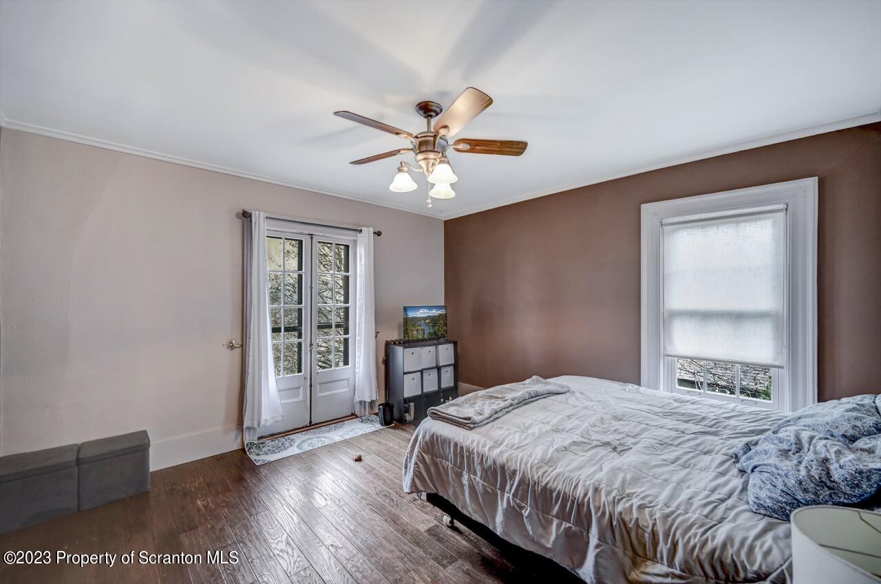 1000 Clay Avenue Scranton, PA 18510 - Photo 60 of 90 a bedroom with a large bed and a chandelier