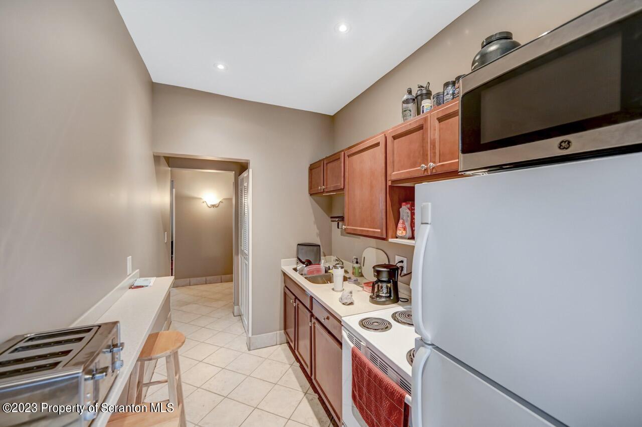 1000 Clay Avenue Scranton, PA 18510 - Photo 65 of 90 a kitchen with stainless steel appliances granite countertop a stove and a microwave